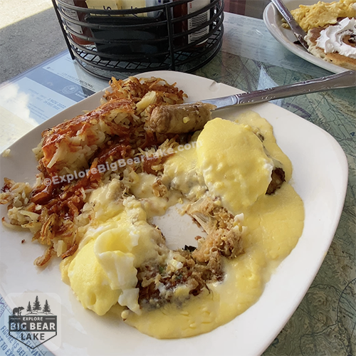 Barnstorm Restaurant flaky crab cake benedict on white plate with hollandaise sauce_copyright_ExploreBigBearLake_dot_com